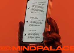 Hand holding smartphone with MINDPALA app